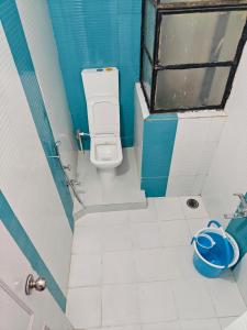 un piccolo bagno con servizi igienici e finestra di Ava Homestay a Indore Altre 23 foto