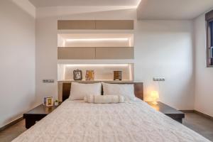 a bedroom with a large white bed in a room at VenMar luxury house in Plataniás