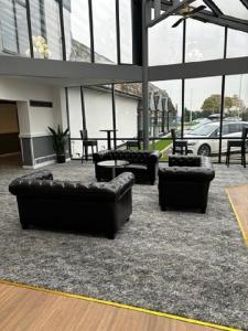 a lobby with couches and tables in a building at Britannia Hotel Wigan in Standish