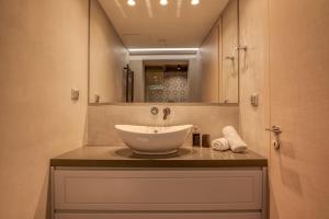 a bathroom with a sink and a mirror at VenMar luxury house in Plataniás +30 photos