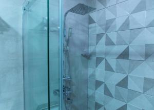 una doccia con una porta in vetro in un bagno di Irmeni Hotel a Tbilisi City