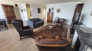 a living room with a couch and chairs and a tv at Saint-Jean de Luz, appartement vue mer 4 couchages in St. Jean de Luz +2 photos