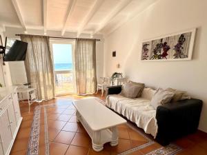 a living room with a couch and a table at Vista Mar - Seafront Holiday Apartments in Santa Maria