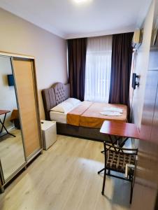 a bedroom with a bed and a table and a mirror at Birol Hotel in Istanbul +20 photos