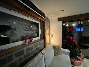 a living room with a christmas tree and a couch at Chaly in Stoumont +13 photos