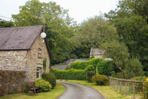 an old stone house on a winding road at Granary Cottage at Scolton Cottages - Indoor pool in HAW