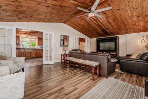 a living room with a ceiling fan and a couch at Blue Horizon Sauna Retreat in Lions Head