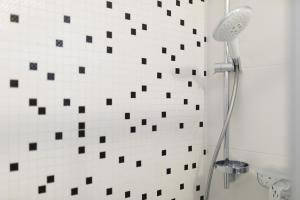 a bathroom with black and white tile on the wall at Relax 3 in Baška +9 photos