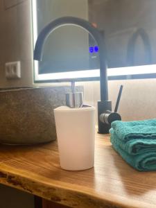 a lamp sitting on a wooden table with a light on it at Ferienwohnung mit Fitnessstudio Top2 in Plauen