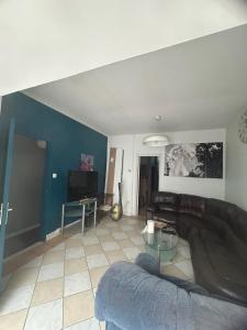 a living room with a couch and a table at Chambre première étage in Lille