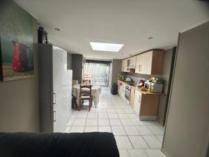 a kitchen and dining room with a table and a kitchen with at Chambre première étage in Lille