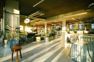 a lobby with a table and a chair in a room at Micampus Braga Student Residence in Braga +18 photos