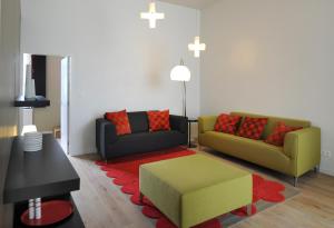 a living room with two couches and a red rug at Le Presbytère in Hermalle-sous-Huy +29 photos