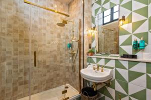 a bathroom with a sink and a shower at Salisbury Arms Hotel in Hertford