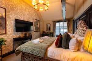 a bedroom with a bed and a flat screen tv at Salisbury Arms Hotel in Hertford