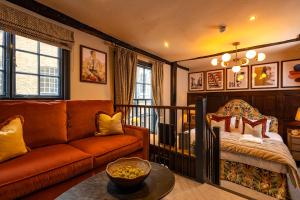 a living room with a couch and a bed at Salisbury Arms Hotel in Hertford +67 photos