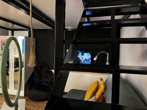 a black bunk bed with a tv in a room at Joanna 2 Apartment with Parking in Larisa