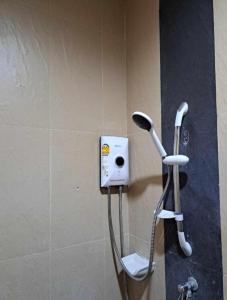 a shower in a bathroom with a phone on the wall at Relax home massage Ao nang 1 in Ao Nang 