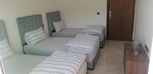 a group of four beds in a room at appartement pres de l aéroport de tanger in Tangier
