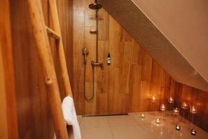 a bathroom with a shower and a sink with candles at Apartament z wanną wolnostojącą in Stare Miasto +33 photos