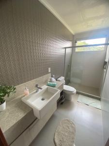 a bathroom with a sink and a toilet at Casas Regiao de Pedra Azul Cverde in Domingos Martins +24 photos