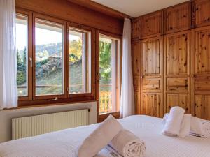 a bedroom with a bed with towels on it at Apartment Ambassador I Apt 7 by Interhome in Nendaz +26 photos