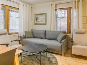 a living room with a couch and a table at Holiday Home Sammal by Interhome in Kukkola