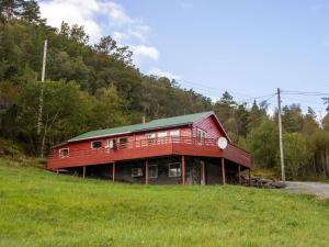 a red house on a hill in a field at Holiday Home Fjordglytt by Interhome in Onarheim