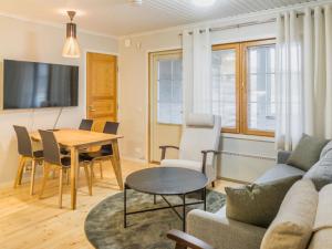 a living room with a couch and a table at Holiday Home Sammal by Interhome in Kukkola