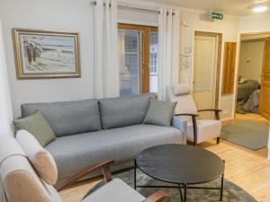 a living room with a couch and a table at Holiday Home Sammal by Interhome in Kukkola +13 photos