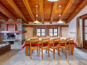 a dining room with a table and chairs and a fireplace at Chalet Casot Pra La Funt by Interhome in Sampeire
