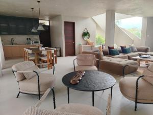 a living room with a couch and chairs and a table at Bahay Lian in Campo