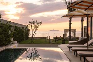 a villa with a swimming pool with a view of the ocean at Bahay Lian in Campo