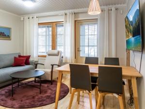 a living room with a table and chairs and a couch at Holiday Home Vadelma by Interhome in Kukkola