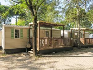 a mobile home with a deck and a gazebo at Holiday Home Camping Laguna Village-1 by Interhome in Porto Falconera