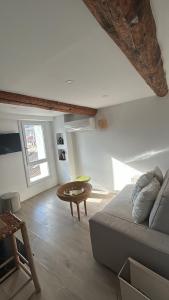 ein Wohnzimmer mit Sofa und Tisch in der Unterkunft Place aux huiles in Marseille + 17 Fotos