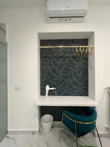 a bathroom with a sink and two chairs at Airport Capodichino Home By Pagnotta in Naples +102 photos