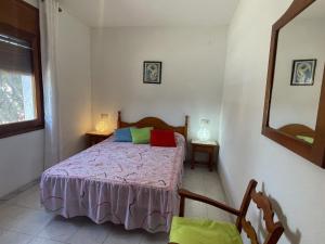 a bedroom with a bed and a mirror at Holiday Home Zaragoza by Interhome in Miami Platja