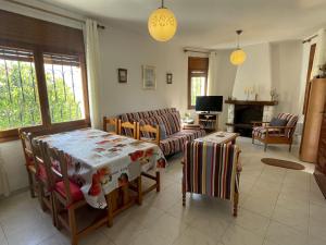 a living room with a table and chairs at Holiday Home Zaragoza by Interhome in Miami Platja