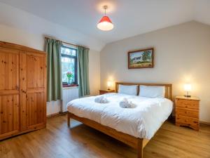 a bedroom with a large white bed and a window at Holiday Home Fishermans by Interhome in Inverness