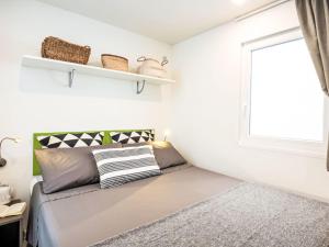 a small bedroom with a bed and a window at Holiday Home Happy Superior by Interhome in Rosapineta