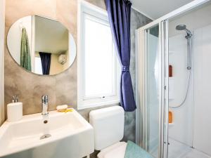 a bathroom with a sink and a mirror at Holiday Home Happy Superior by Interhome in Rosapineta +23 photos