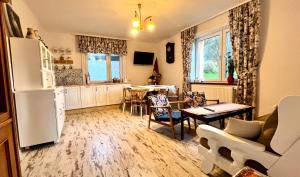 a kitchen and living room with a refrigerator and a table at zaKRZYWEk retro in Cisna