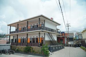a building with a balcony on the side of it at Parama Bromo Hotel in Ngadisari