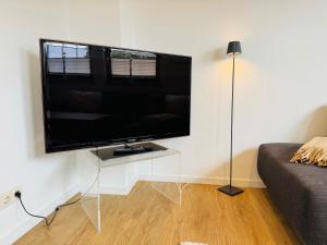 a large flat screen tv on a wall in a living room at App Blaue Welle in Morsum