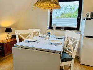 a kitchen with a table with glasses on it at App Blaue Welle in Morsum