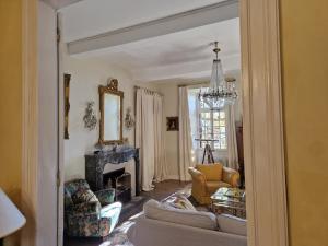 a living room with a couch and a fireplace at Chateau Ventenac in Ventenac en Minervois