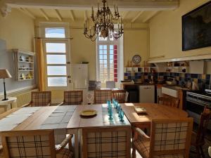 a kitchen and dining room with a wooden table and chairs at Chateau Ventenac in Ventenac en Minervois