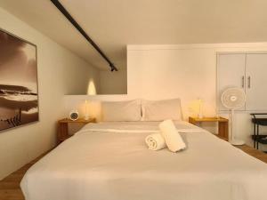 吉隆坡SkyView Studio, EST Bangsar, High View for 2的白色卧室配有一张大白色床和2条毛巾