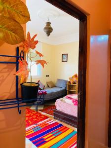 a living room with a couch and a mirror at Taliouine Apartments in Taghazout